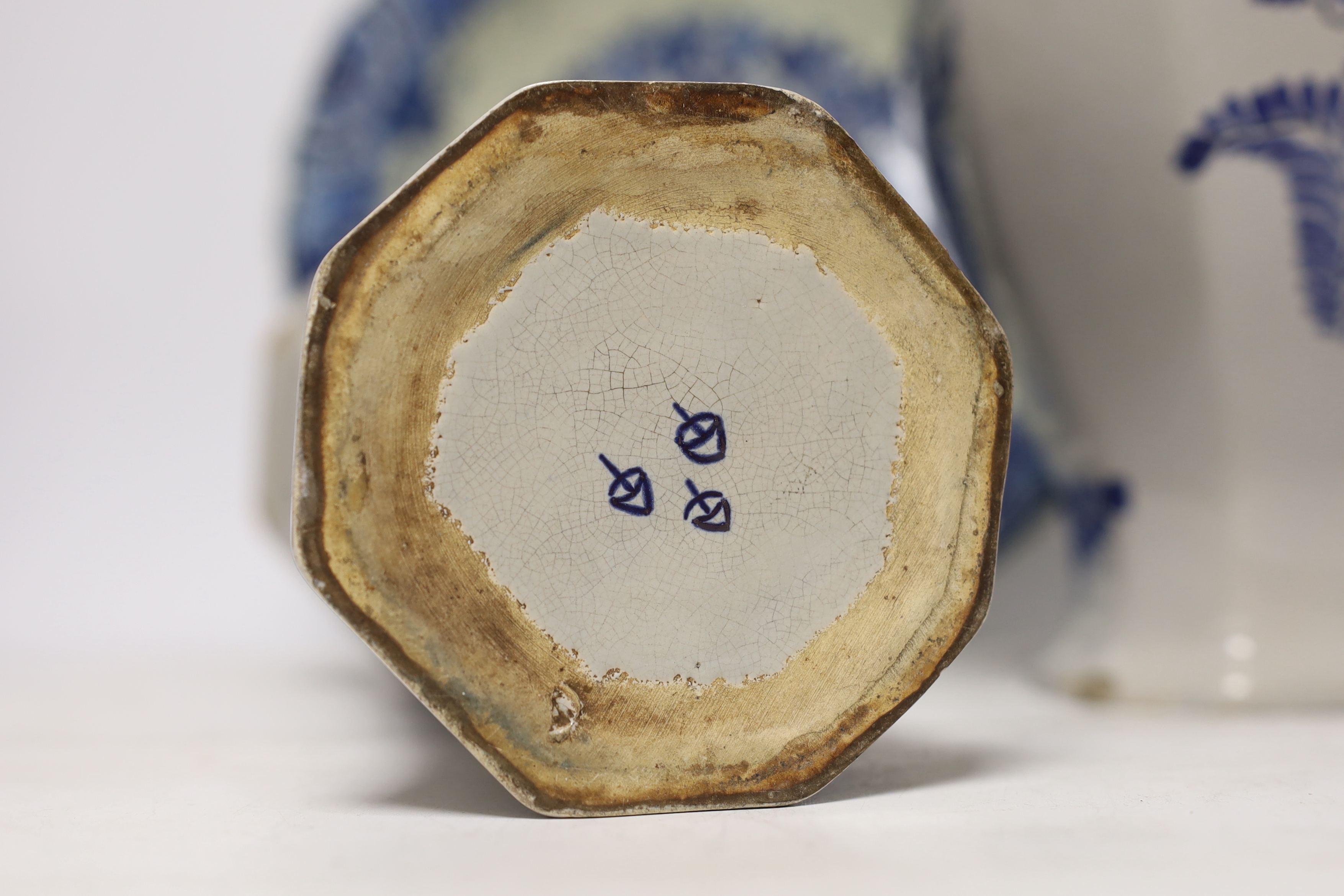A late 18th century Delft garniture of three vases, two with covers, 32cm, together with a modern Delft plate